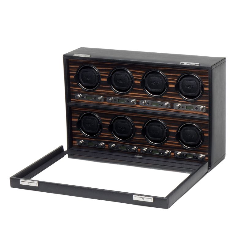 The WOLF 1834 Roadster 8 Piece Winder is an elegant black leather accessory that beautifully showcases your timepieces with its eight slots arranged in two rows of four. It features a luxurious ebony macassar interior and includes a bi-directional setting, while the open front panel offers a perfect view of the watches nestled inside.