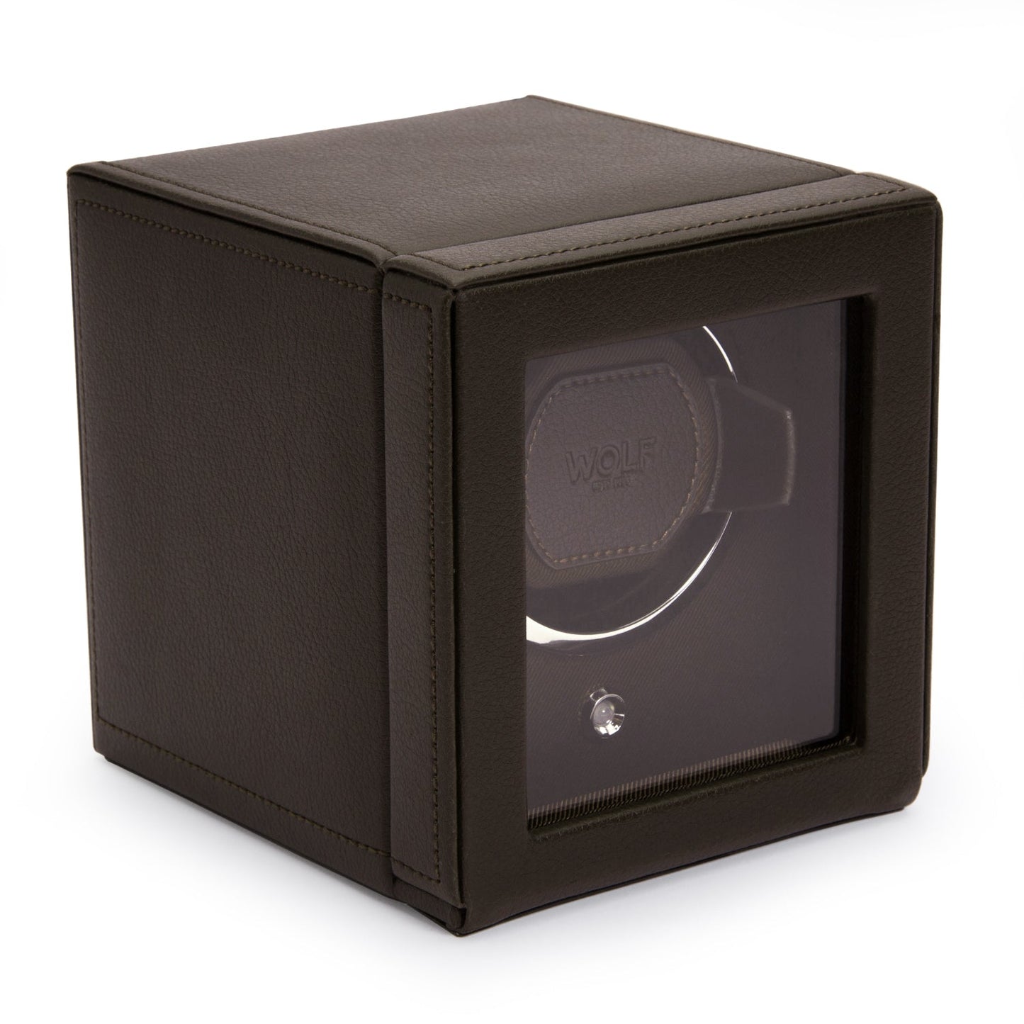 A sleek black vegan leather WOLF 1834 Cub Single Watch Winder with a transparent front prominently displays the word "WOLF" inside. This square-shaped device features a small metallic knob on the front panel, highlighting its patented rotation system.
