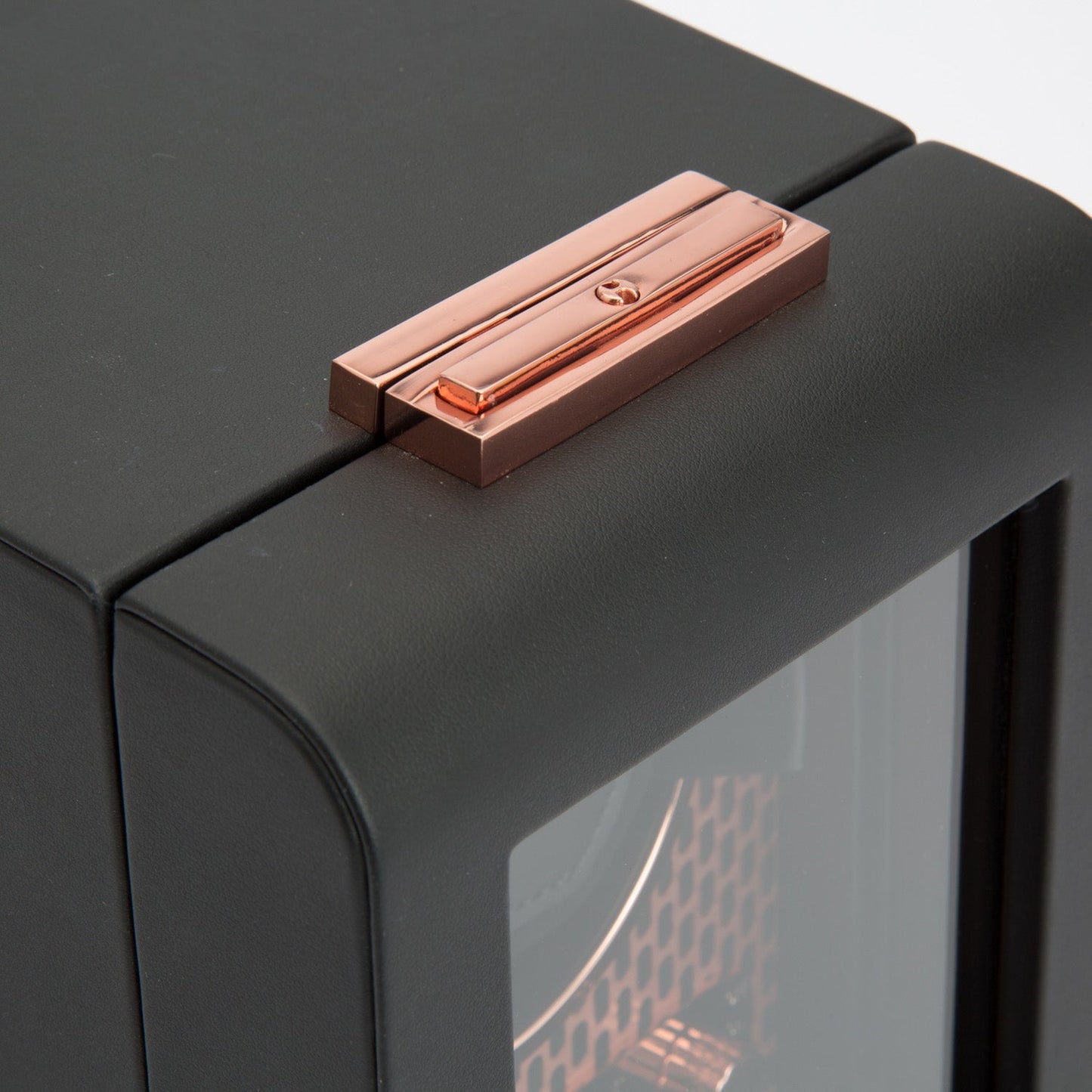 The WOLF 1834 Axis Single Watch Winder features a sleek, modern design with a black leather exterior, enhanced by a glass door and rose gold latch. This watch winder not only offers a glimpse of luxury but also provides various rotation options and power reserve settings for ultimate functionality.