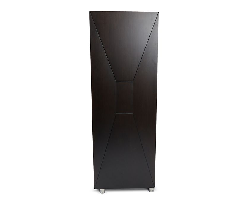 A tall, modern WOLF 1834 Churchill 24 Piece Winder Safe by WOLF occupies the image. It stands on small metal feet and features sleek, angular lines on its front panel, creating a contemporary aesthetic.