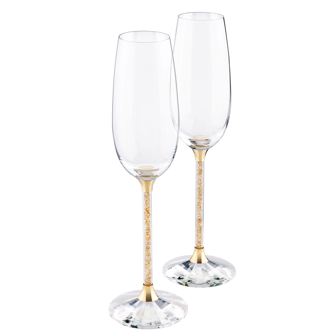 The Swarovski Gold Tone Crystalline Toasting Flutes, a set of two with gold-colored stems and bases adorned with Golden Shadow crystals, are elegantly displayed on a simple white background, making them ideal for special occasions.