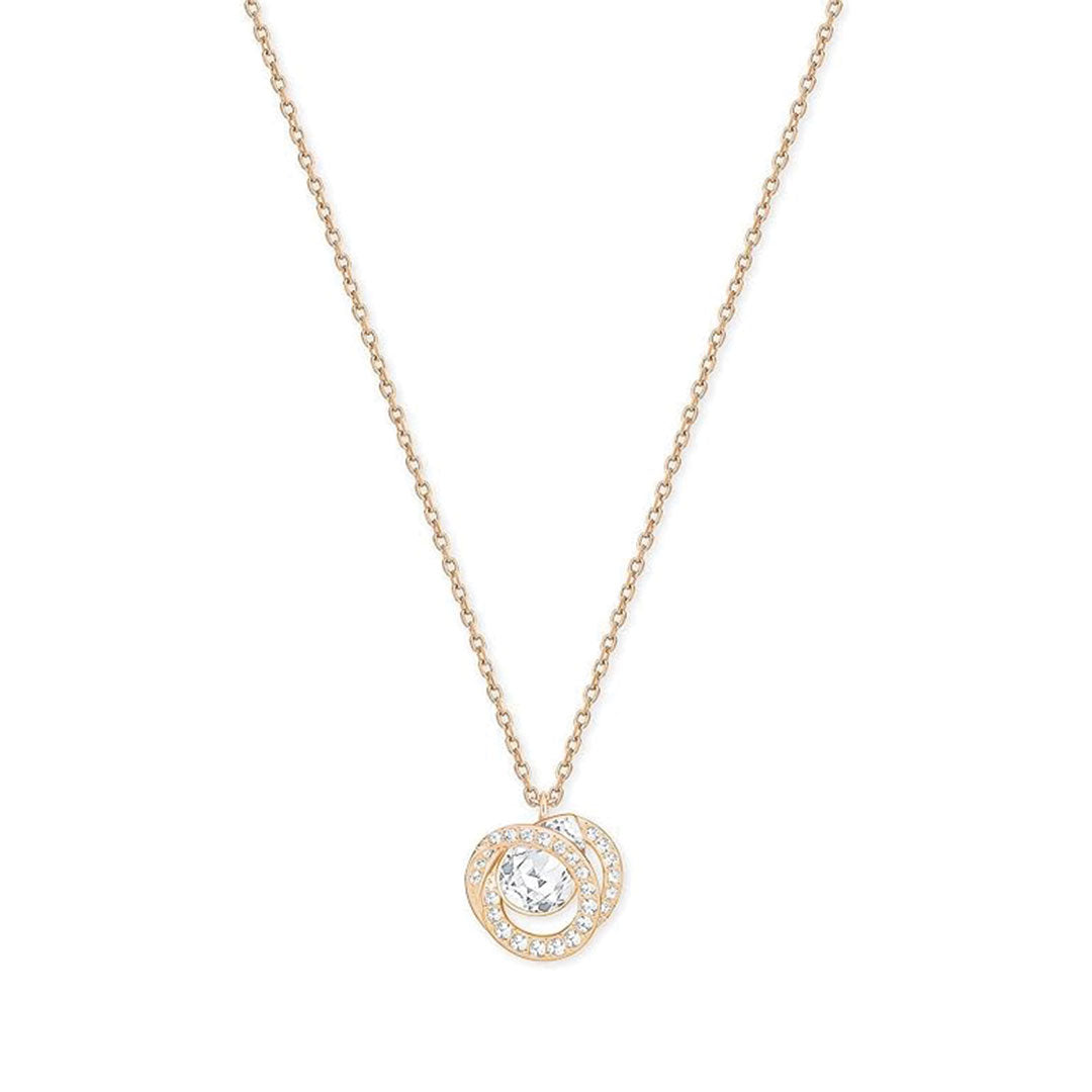 The Swarovski Generation Necklace Pendant by Swarovski is a refined rose gold-plated piece featuring a round centerpiece adorned with a clear central gemstone. This striking pendant is surrounded by a dazzling halo of smaller stones, and it hangs from a simple yet elegant chain that beautifully accentuates the intricate design.