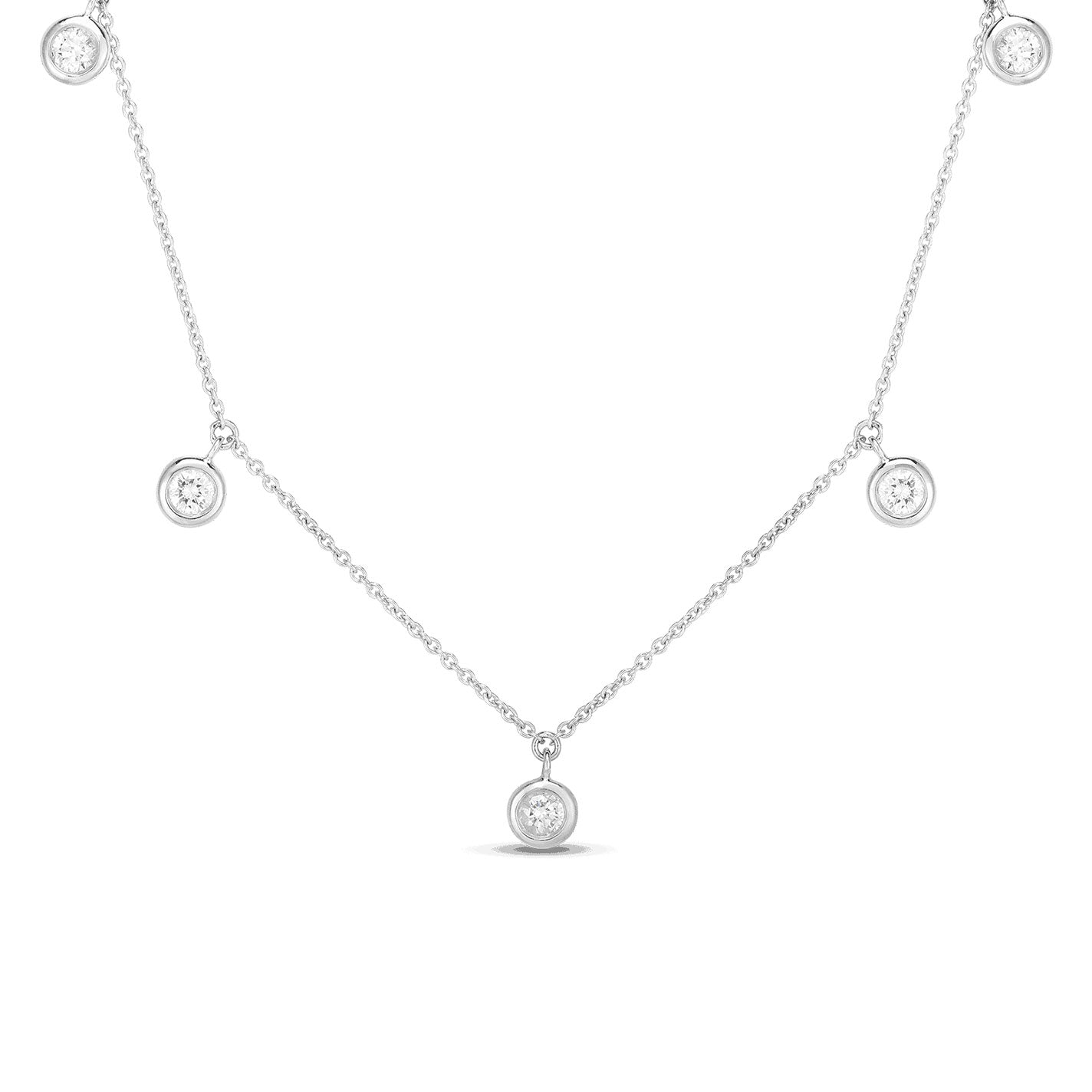 The Roberto Coin Diamonds By The Inch 18K White Gold Dangling Five Station Necklace showcases an elegant and simple design. Featuring a series of small round pendants with sparkling gems evenly spaced along the chain, this necklace highlights the shimmer of its diamonds against the delicate white gold backdrop.