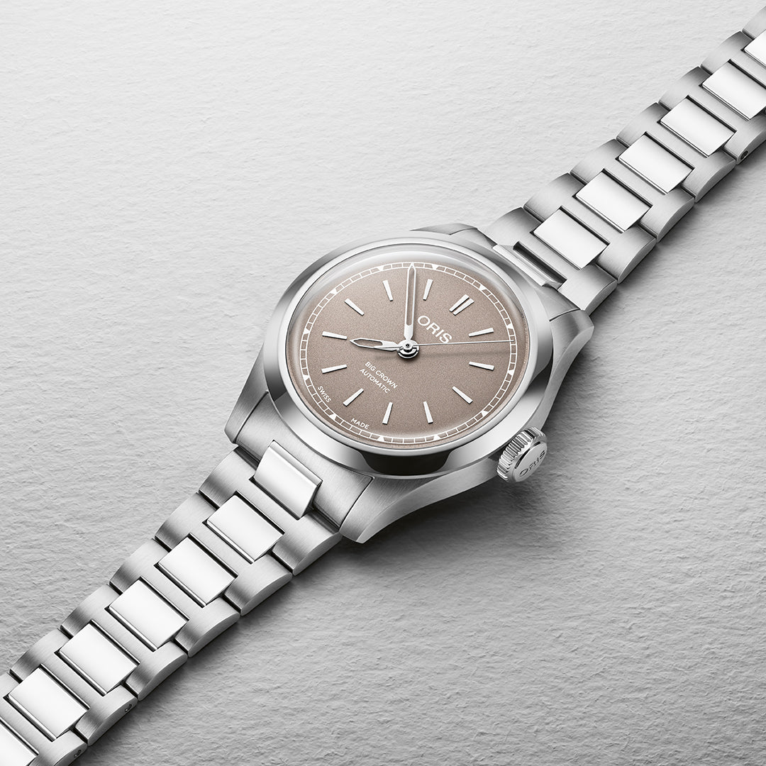 The Oris Big Crown Calibre 531 Automatic Winding 34mm Watch features a stainless steel design with a grey dial, silver hour markers, and metal link bracelet. Designed for smaller wrists, it displays "Oris" on its textured background, offering Swiss Made precision.