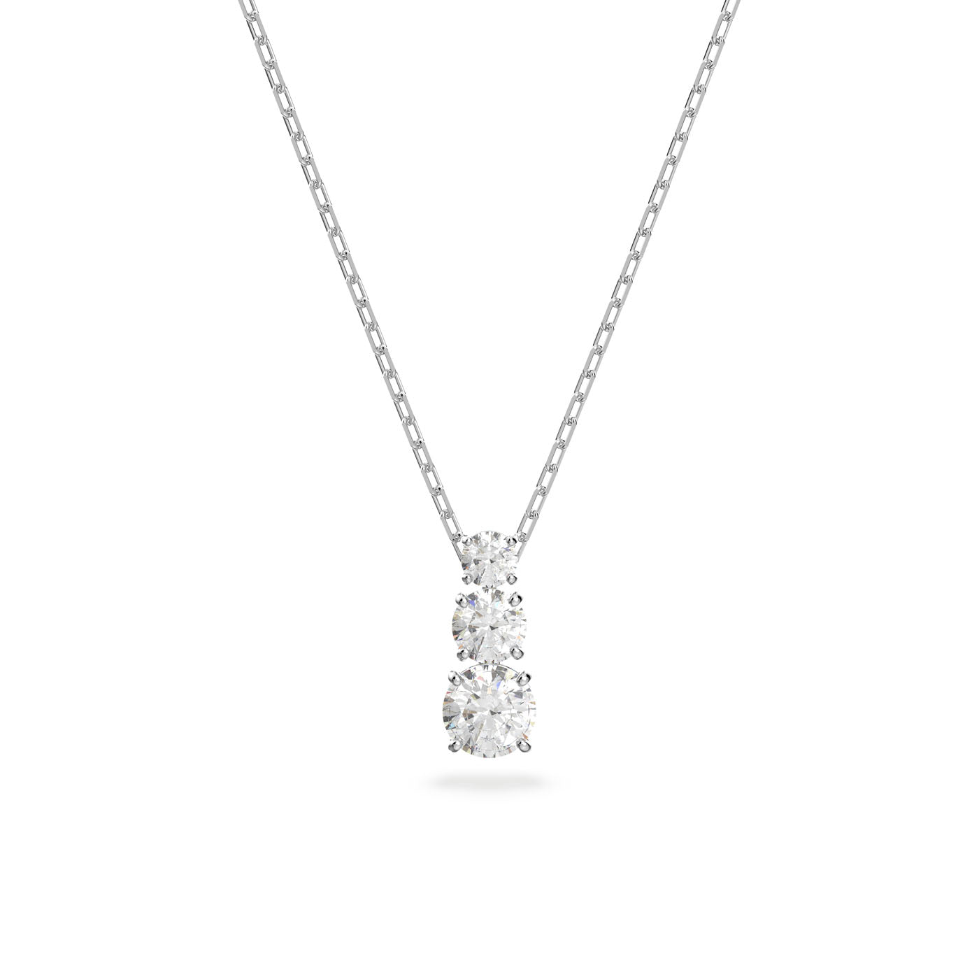 Discover the Swarovski Pendant Attract Trilogy Necklace Pendant, an exquisite creation from Swarovski. This silver necklace showcases three round diamond pendants of varying sizes, each elegantly set in simple prong settings. The fine-link chain adds to its graceful beauty against a plain white background, embodying eternal love.