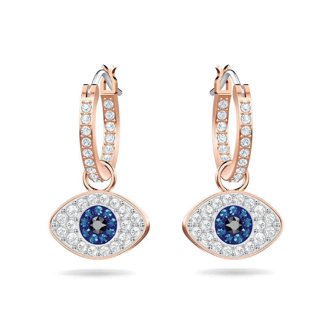 The Swarovski Evil Eye Hoop Earrings by Swarovski feature rose gold pavé hoops adorned with small clear stones, complemented by eye-shaped pendants. Each pendant showcases a central black stone encircled by blue and clear stones, forming the iconic protective evil eye symbol.