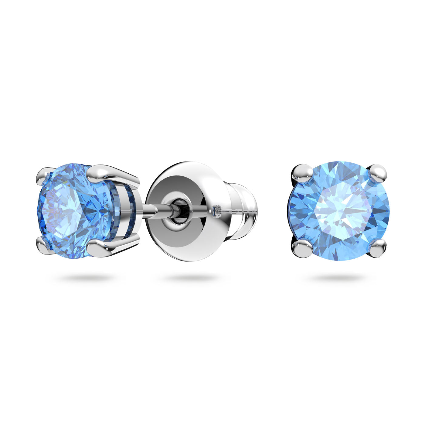 The Swarovski Crystal Sparkling Dance Jewellery Set includes a pair of silver stud earrings with a pastel blue stone in a dynamic design, secured by four prongs. One earring is displayed from the side to feature the push-back closure, while the other focuses on the front view, highlighting the gemstone's brilliance.