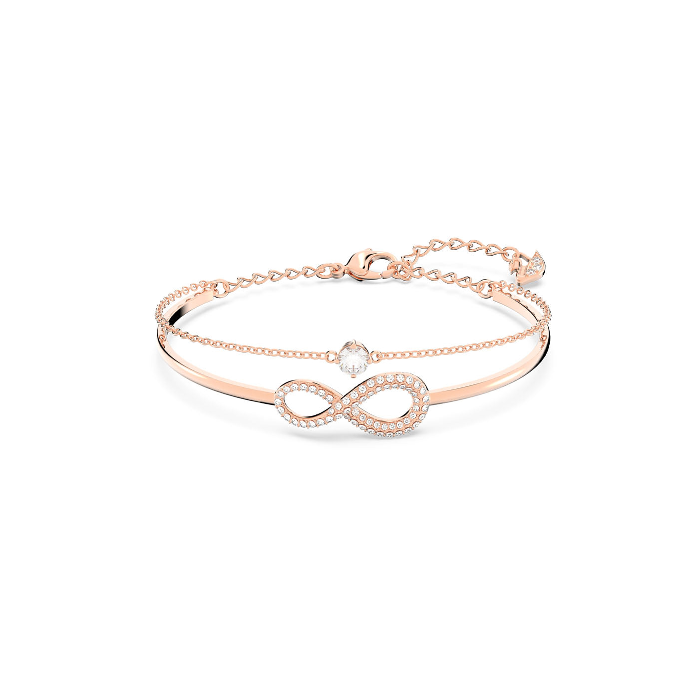 The Swarovski Infinity Bangle from Swarovski features a rose-gold tone bracelet with a delicate chain, showcasing an intricate infinity symbol embellished with white crystals. A central marquise-cut crystal adds an elegant touch, while the adjustable clasp ensures a customizable fit.