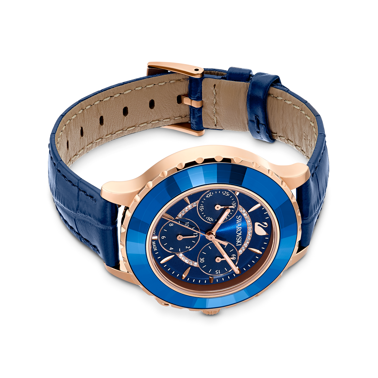 Introducing the Octea Lux Chrono watch by Swarovski, a Swiss-made luxury timepiece featuring a quartz movement and an elegant blue leather strap complemented by a rose gold-tone finish. The watch's face displays three subdials, bold metallic markers, and proudly showcases the Swarovski brand name.