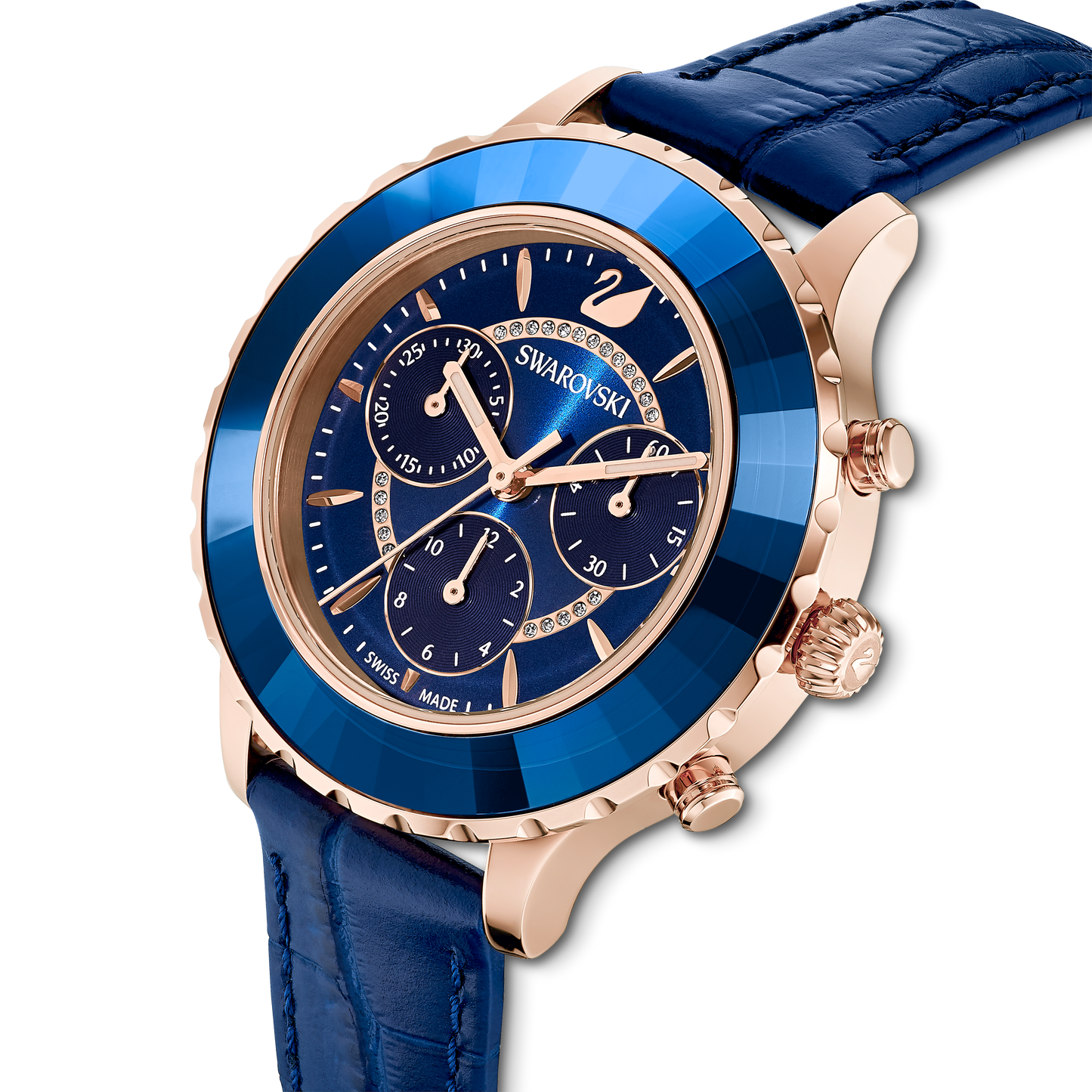 Indulge in luxury with the Swarovski Octea Lux Chrono watch, expertly crafted with a captivating rose gold-tone finish and a blue crystal bezel. The stylish blue leather strap perfectly complements the dial's exquisite gold and crystal details. This Swiss-made quartz timepiece features sub-dials and elegantly designed watch hands, offering a timeless accessory for any occasion.