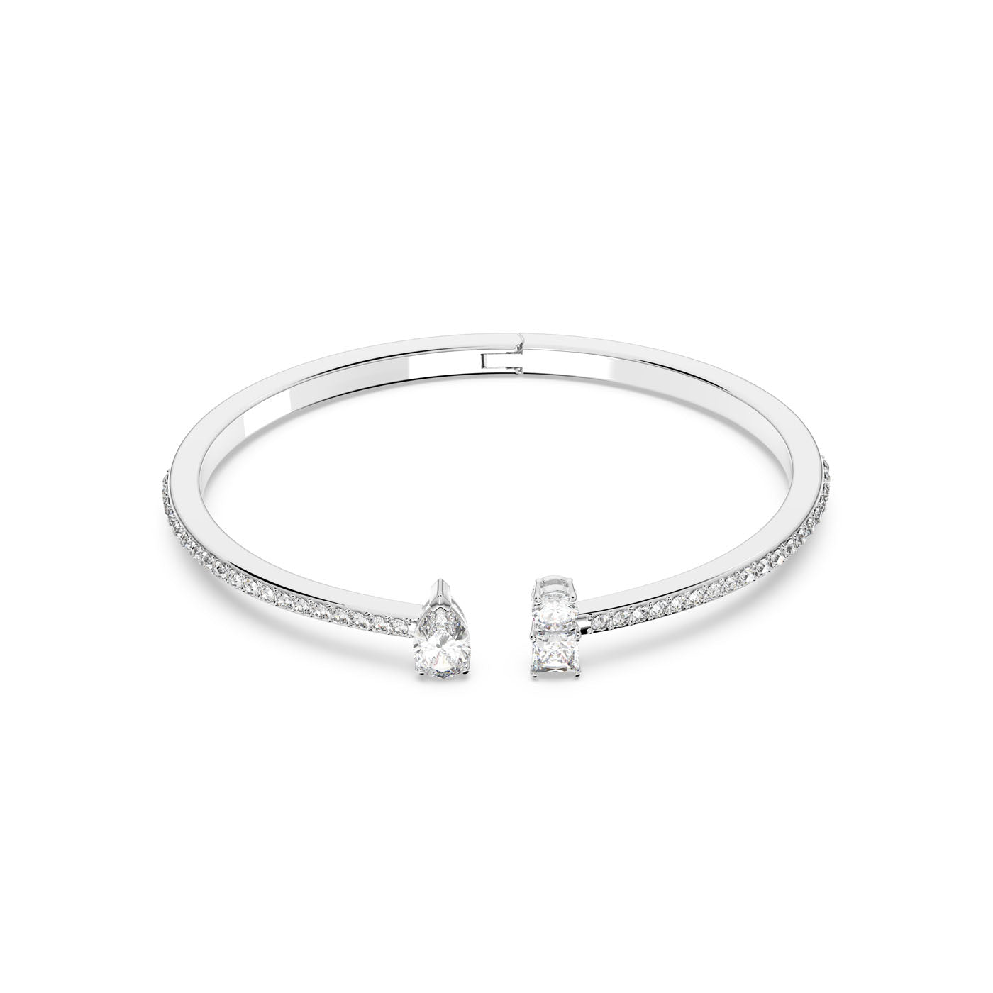 Introducing the Swarovski Mixed Cuts Attract Cuffs from the renowned brand Swarovski, showcasing a timeless open-ended design. This silver bracelet features a pear-shaped and a square-shaped gemstone at each end, adorned with small pavé stones along the band for added elegance.