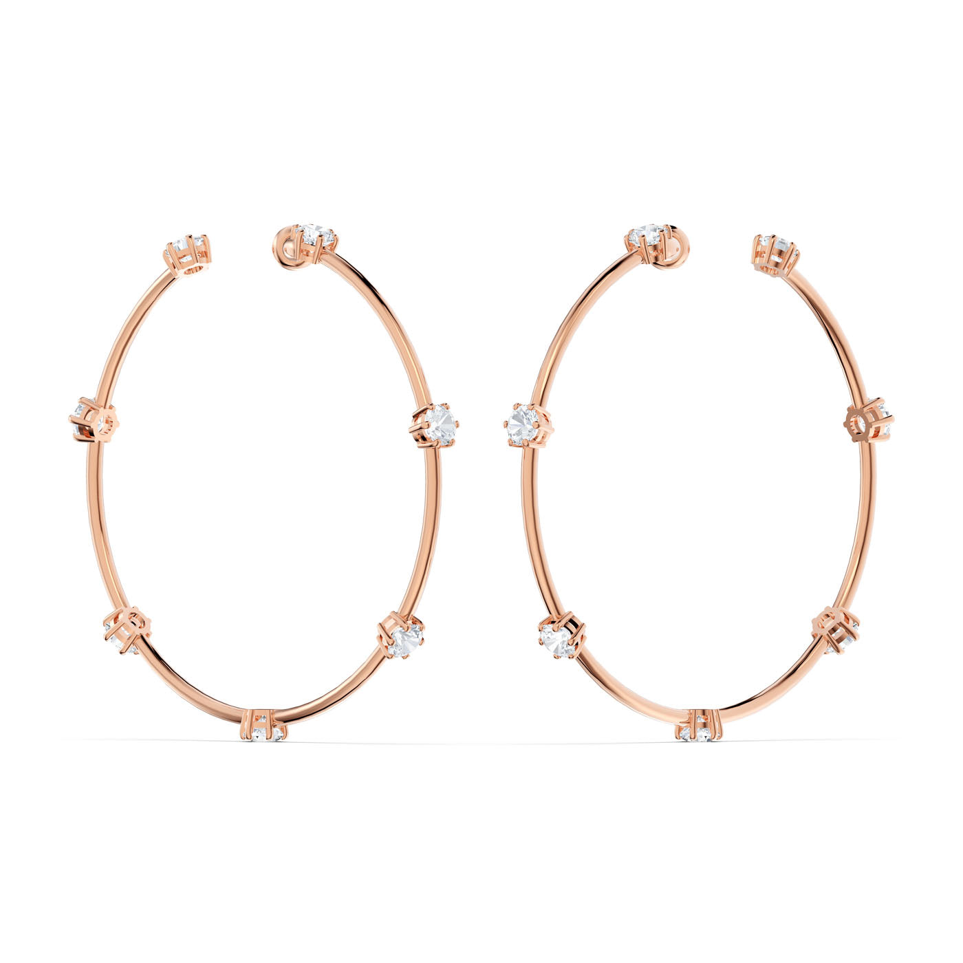 Introducing the exquisite Swarovski Constella Hoop Earrings, a pair of rose gold-tone plated hoop earrings from Swarovski. These minimalist marvels feature evenly spaced diamond-like stones that dazzle with brilliance against the sleek, modern design of the warm metal backdrop.