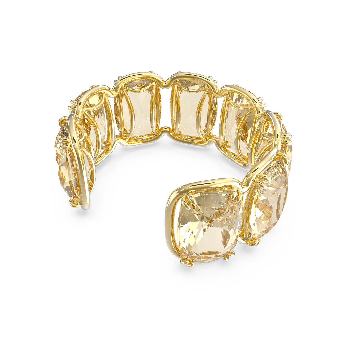 The Swarovski Gold Tone Oversized Floating Crystals Harmonia Cuff by Swarovski features elongated cushion-cut crystals and floating stones set in linked bezels, offering an elegant and luxurious design.
