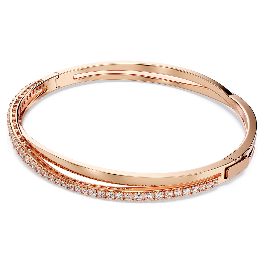 Introducing the Swarovski Hyperbola Bracelet, a sleek rose-gold bangle from Swarovski that features a row of sparkling zirconia stones. This bracelet boasts a minimalist and elegant design, making it ideal for achieving a refined and classic luxury look.