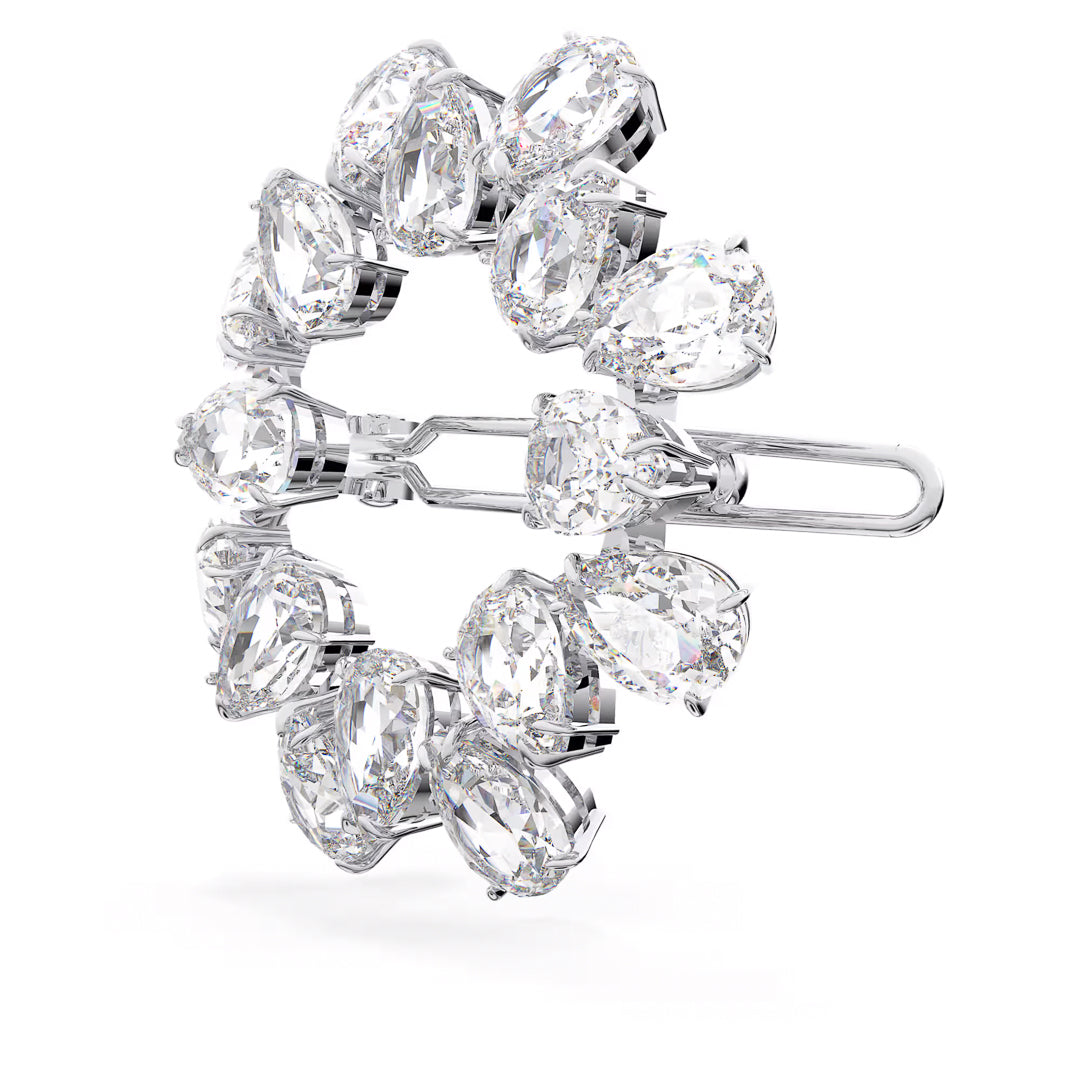The Swarovski Millenia Hair Clip is a sparkling circular accessory adorned with large pear-cut crystals in a symmetrical design set in silver-tone metal. As part of the Millenia collection, this elegant piece serves as both a brooch and a hair clip, featuring a secure clasp for versatile styling options.