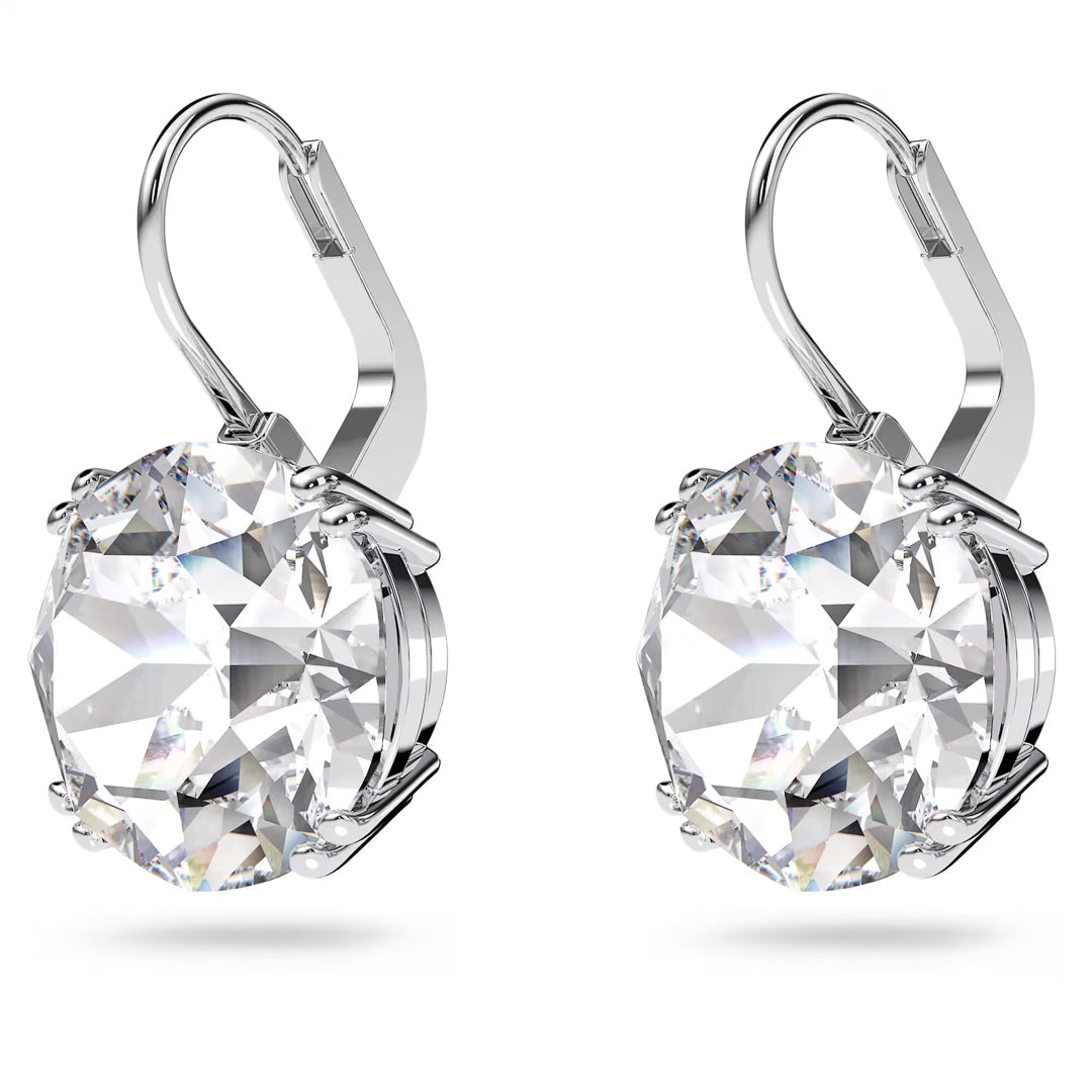 Introducing the Swarovski Millenia Drop Earrings by Swarovski: a sophisticated pair of drop earrings adorned with large, round-cut crystals encased in a rhodium-plated setting. The classic design features secure lever-back closures for an elegant touch. These gemstones artfully capture light, creating an enchanting sparkling effect.