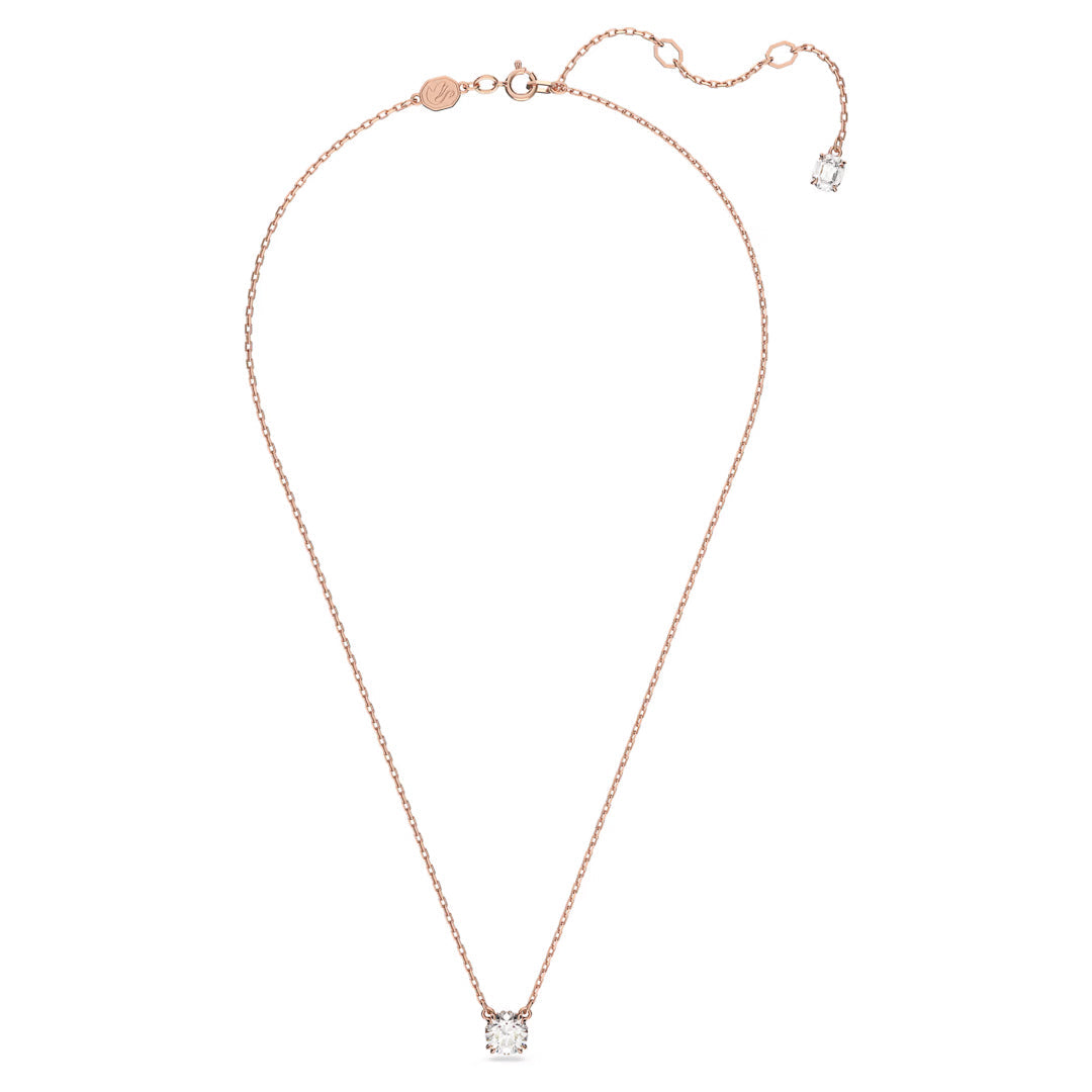 The Swarovski Stilla Necklace Pendant by Swarovski features a delicate rose gold-tone plated chain with a stunning round-cut diamond pendant. The necklace is designed with an adjustable clasp and includes an additional smaller octagon-cut stone charm at the end of the extension.