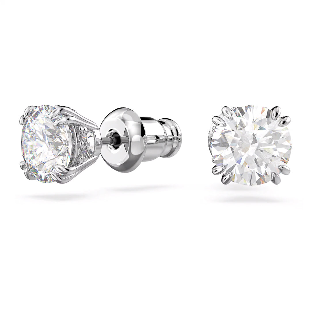 The Swarovski Stilla Stud Earrings feature large, round zirconia gemstones in a prong setting, complemented by a shiny rhodium-plated post and butterfly backings. These elegant silver stud earrings are beautifully displayed against a plain white background.