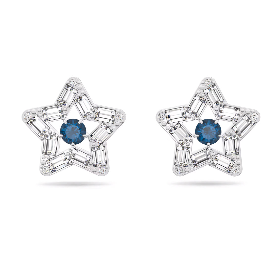 The Swarovski Stilla Stud Earrings, crafted by Swarovski, feature a star-shaped motif with a central blue gemstone surrounded by clear rectangular stones for an eye-catching display. Rhodium plating enhances their brilliance, while their symmetrical design elegantly emphasizes the contrasting colors.