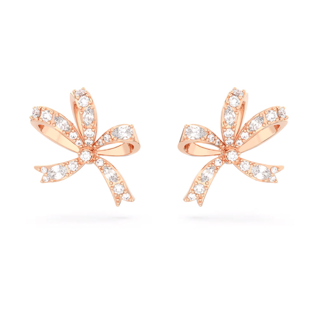 The Swarovski Hyperbola Stud Earrings by Swarovski are elegant bow-inspired studs in rose gold, featuring clear crystals and set against a plain white background.