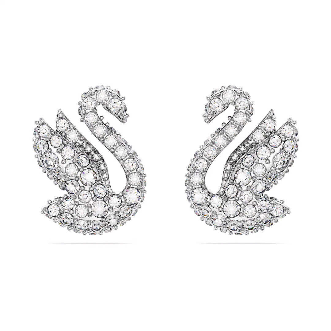 The Swarovski Swan Stud Earrings, featuring an elegant and symmetrical design adorned with pavé crystals, are finished with rhodium plating for a dazzling effect.