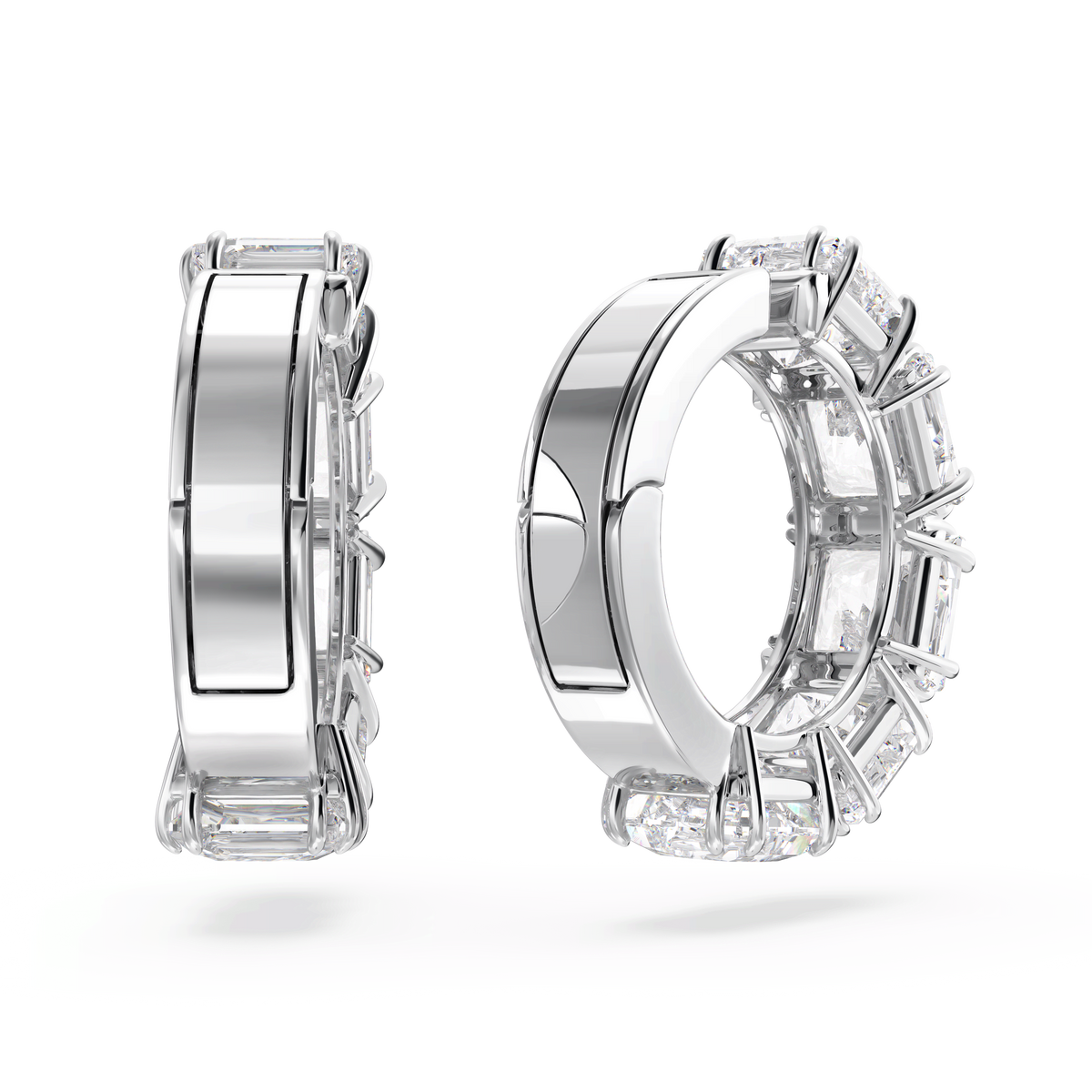 The Swarovski Matrix clip earrings are displayed upright and side-by-side against a white background. One earring features a smooth, polished rhodium plated surface, while the other is adorned with square cut white gemstones set in prongs along its outer edge. Both earrings embody the refined brilliance characteristic of Swarovski’s jewelry design.