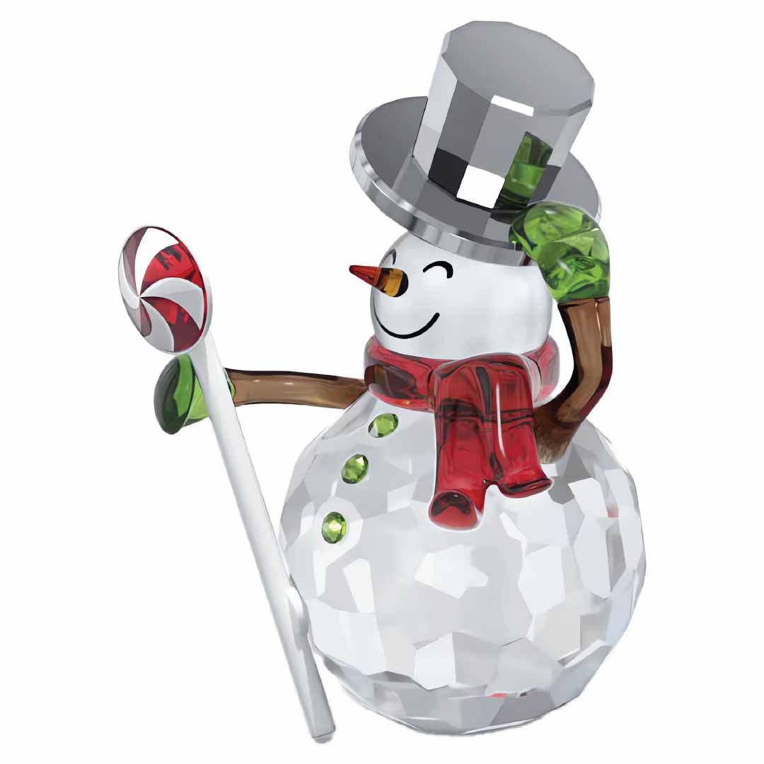 The Swarovski Holiday Cheers Dulcis Snowman Home Décor from Swarovski features a crystal snowman figurine with a faceted body, wearing a crystallized hat and scarf. It holds a candy cane and is ideal for the festive season, showcasing green mittens and buttons, along with the timeless carrot nose.