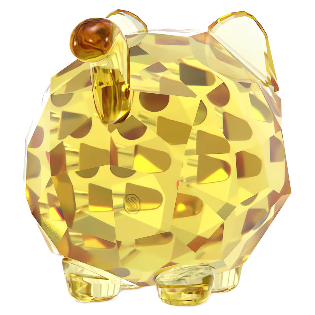 The Swarovski Chubby Yellow Cat Home Décor piece resembles a round animal adorned with abstract geometric patterns, featuring small feet, ears, and a tail. Its reflective, faceted surface adds charm to this collectible piece that echoes the elegance associated with the Swarovski brand.