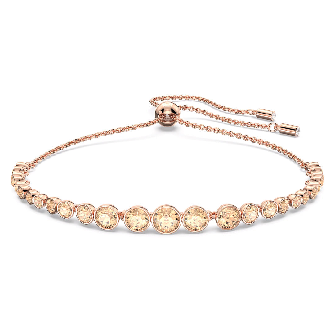 From the Swarovski Imber Emily collection, this rose gold bracelet showcases round pink crystals arranged in a linear pattern, complemented by an adjustable chain and sliding clasp. Its sophisticated design captures and reflects light, infusing a sense of luxury.