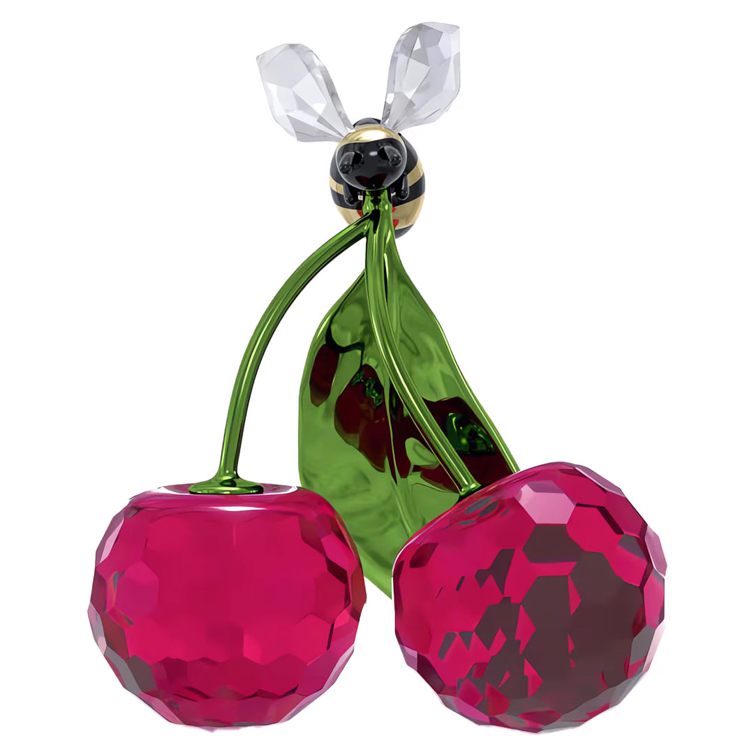Experience the captivating artistry of the Swarovski Idyllia Bee and Cherry Home Décor, featuring two faceted red cherries with green glass leaves and a detailed bee with transparent wings and a shiny black body. This piece by Swarovski showcases vibrant elements artistically crafted in lacquered metal, sure to captivate any observer.