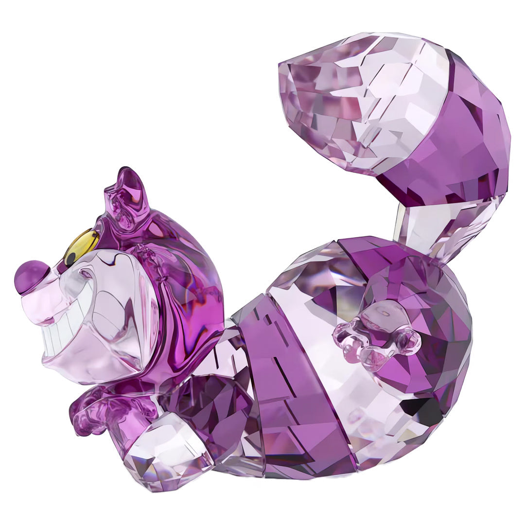 The Swarovski Alice in Wonderland Cheshire Cat Home Décor piece, expertly crafted from sparkling Swarovski crystals, features a whimsical grin and playful pose reminiscent of the beloved character. Its purple and pink striped design, along with the curved tail, captures an enchanting charm that dazzles with every facet.