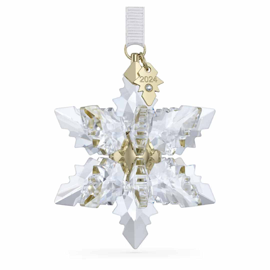 The Swarovski 2024 Annual Editions 3D Ornament Home Décor showcases a breathtaking 3D snowflake design with a gold metal center and includes a golden tag engraved with "2024." This exquisite ornament gracefully hangs from a white ribbon, bringing timeless charm to your holiday decorations.