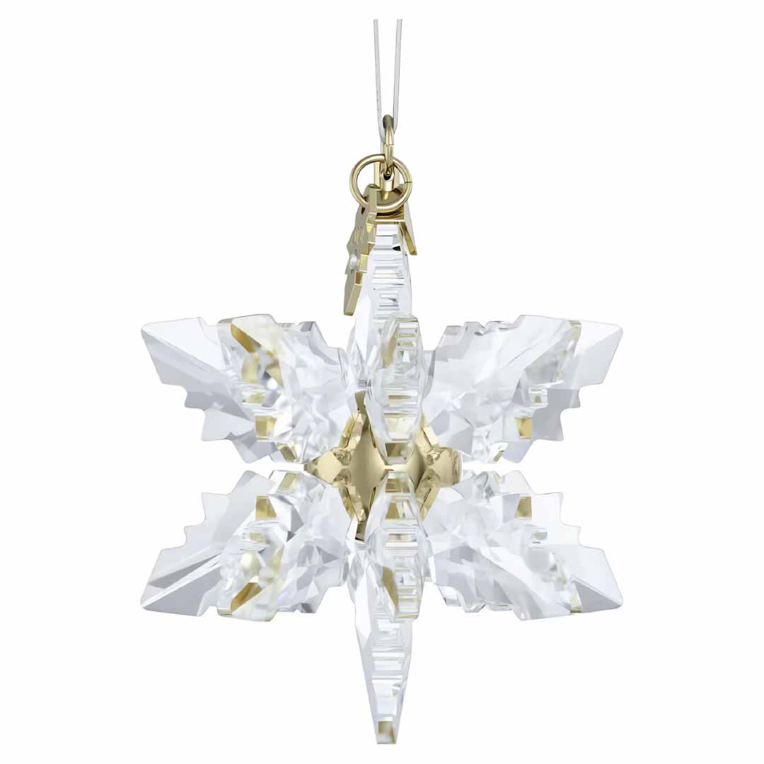 The Swarovski 2024 Annual Editions 3D Ornament Home Décor, featuring a crystal snowflake adorned with gold accents, elegantly hangs from a white string to enhance your holiday décor. Its intricate 3D design snowflakes beautifully shimmer in the light.