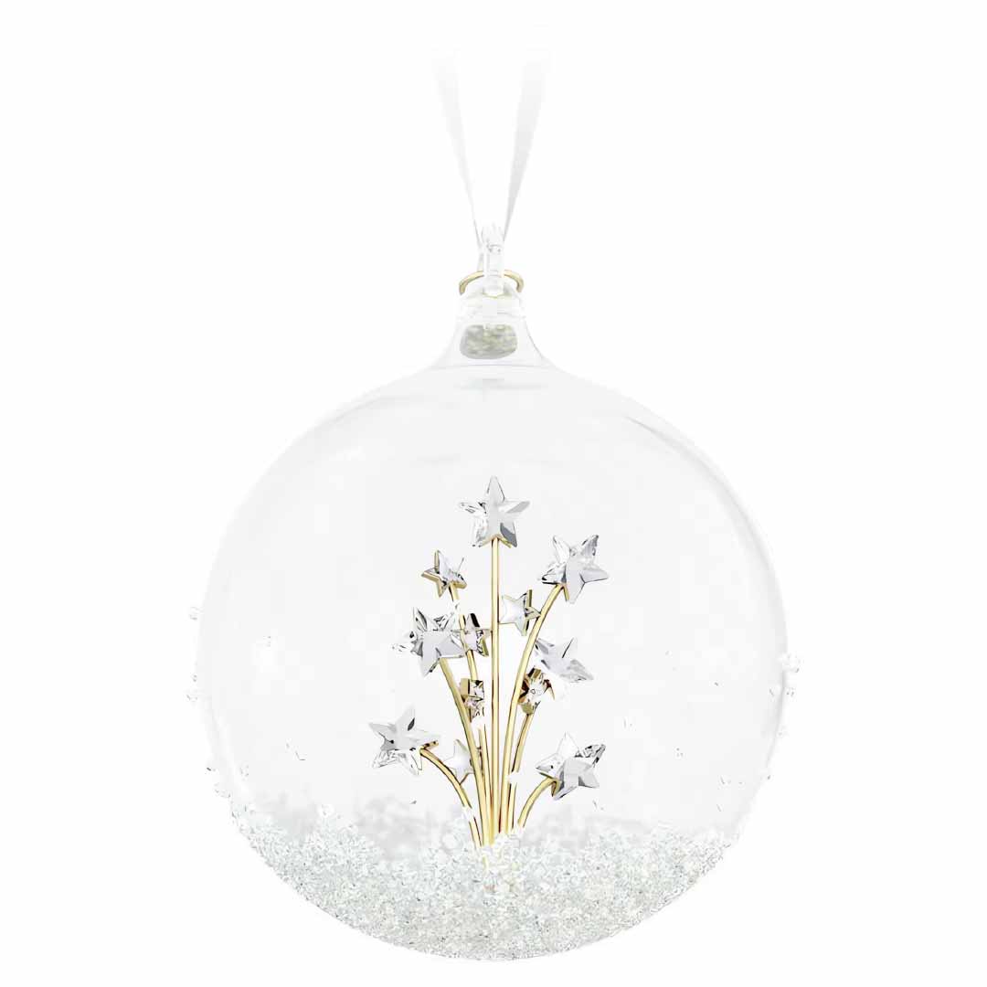 Presenting the Swarovski 2024 Annual Edition Ball Ornament Home Décor by Swarovski: a clear glass ornament adorned with a stunning cluster of gold and silver star decorations. The base dazzles with white glitter, while it hangs elegantly from a white ribbon, making it an ideal festive decoration.
