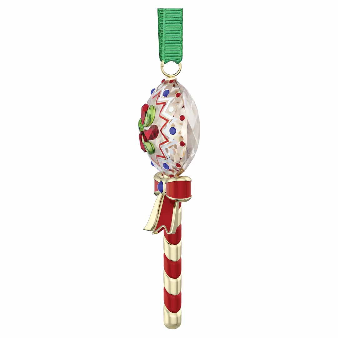 The Swarovski Holiday Cheers Dulcis Lollipop Ornament from Swarovski is a stunning crystallised piece, showcasing a crystal-like oval with a vivid red bow and lush green leaves on a candy cane-striped stick, enhanced with elegant red and gold accents, all elegantly suspended from a festive green ribbon.