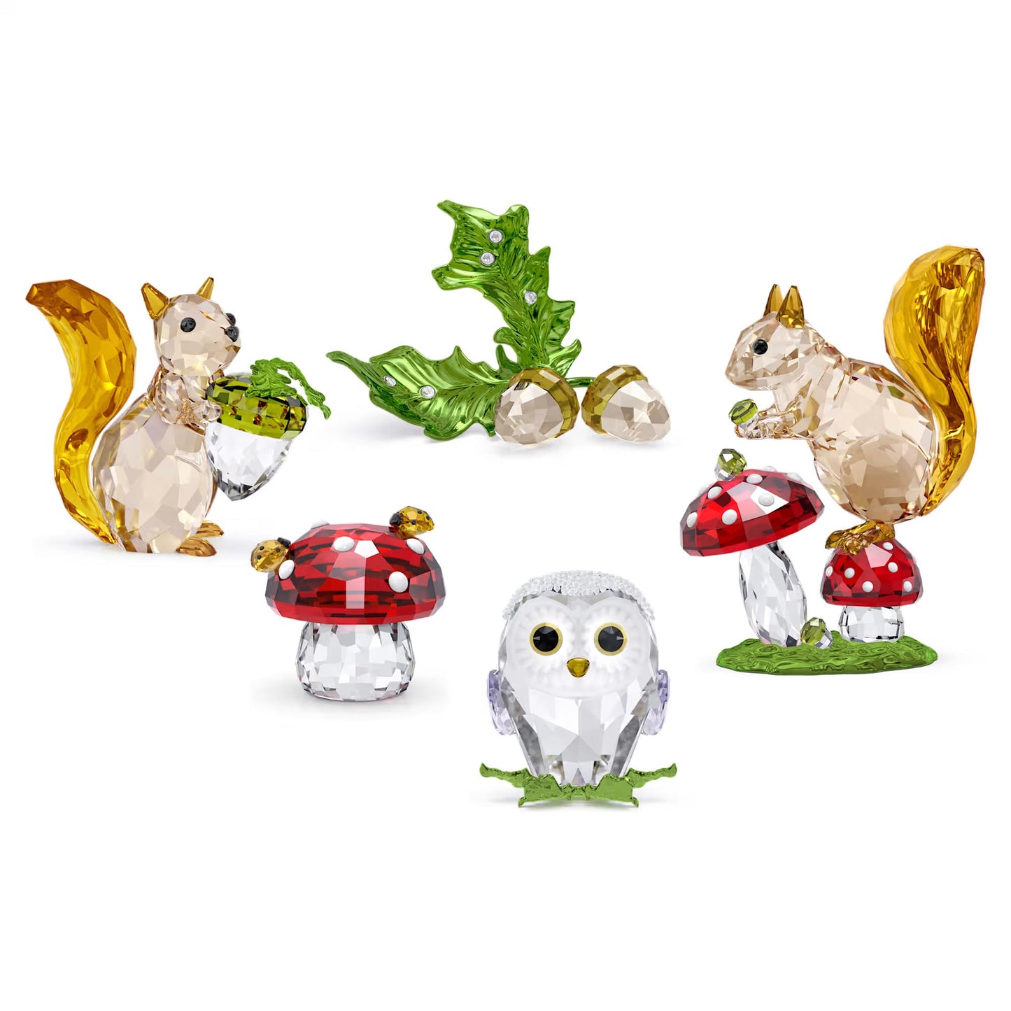 Discover the Swarovski Idyllia Squirrel and Mushrooms Home Décor collection, a sparkling set of crystal figurines featuring intricately detailed designs. Central to the collection are two squirrels holding green acorns and an owl encircled by red mushrooms with white spots. This enchanting ensemble embodies nature's whimsy and elegance in a brilliant style.