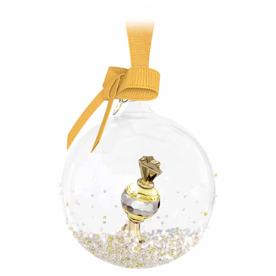 A crystal-clear glass ornament encases white beads and showcases a petite, golden perfume bottle, closely mirroring the Swarovski Holiday Cheers Dulcis Bell Ornament Home Décor. Adorned with a dazzling gold ribbon bow, it captures the festive spirit of Swarovski.