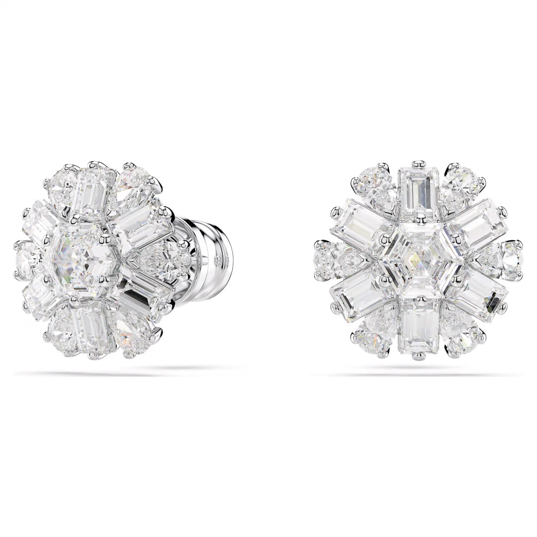 Introducing the Swarovski Idyllia Stud Earrings by Swarovski, these exquisite snowflake-inspired earrings showcase a floral design with a sparkling arrangement of round and emerald-cut stones set in rhodium-plated metal.