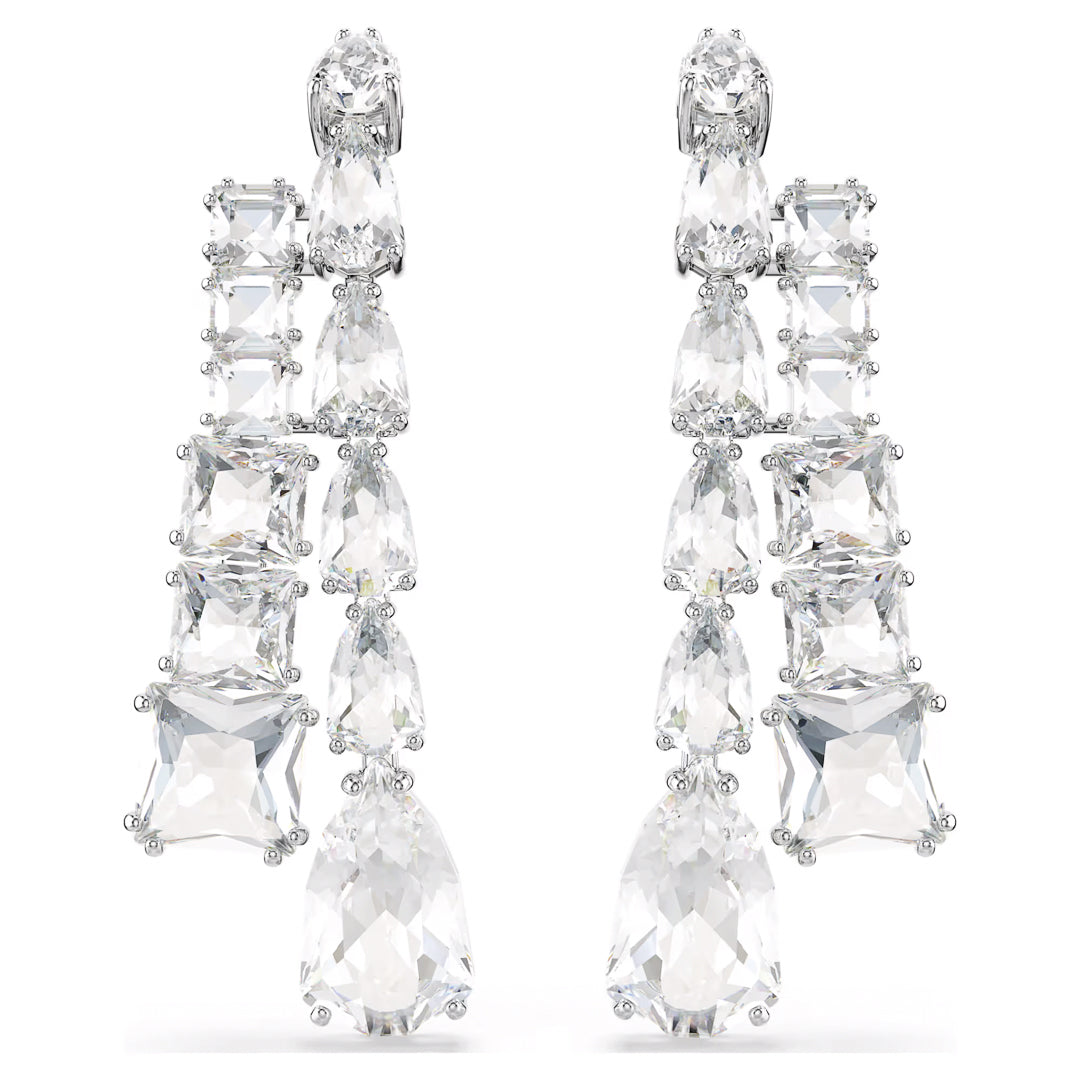 The Swarovski Matrix Drop Earrings are a stunning piece from the Swarovski brand, showcasing an array of large, sparkling clear crystals elegantly set in silver. The design incorporates various shapes to create a cascading effect, making them ideal for formal occasions or adding a touch of glamour to any outfit.