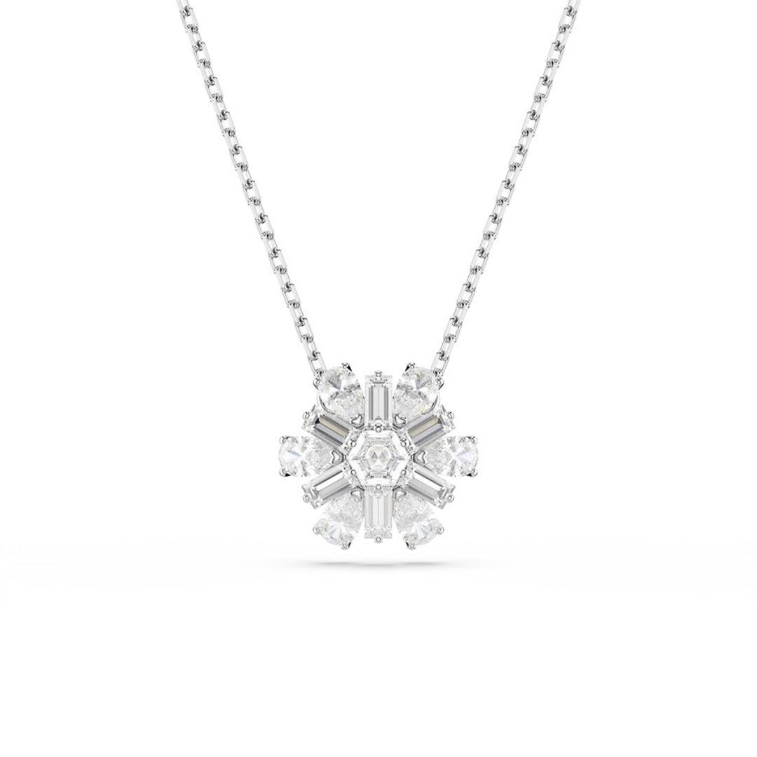The Swarovski Idyllia Necklace Pendant by Swarovski is a rhodium-plated silver necklace featuring a snowflake-shaped design adorned with sparkling white crystals that are symmetrically arranged around a central stone.