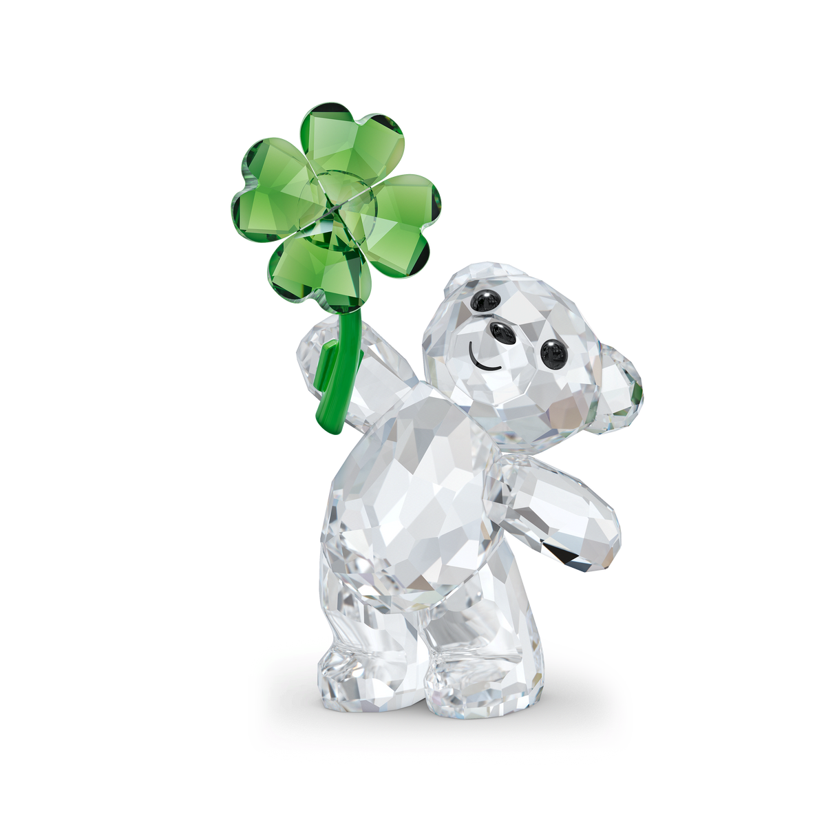 The Swarovski Kris Bear Lucky Charm figurine features a clear crystal bear standing on its hind legs with a cheerful expression, holding a green four-leaf clover. With sparkling black crystal eyes and nose, this adorable creation by Swarovski makes the perfect lucky charm.