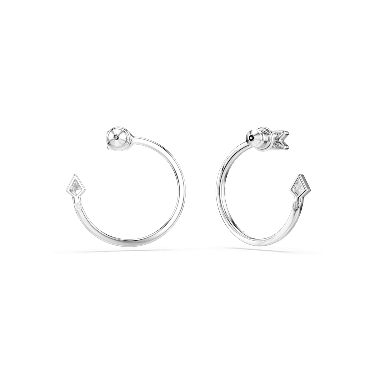 A pair of Swarovski Idyllia hoop earrings in rhodium-plated silver, featuring mixed-cut designs with one end adorned by a round bead and the other highlighted by a small arrow-inspired diamond-shaped accent, are displayed on a plain white background.