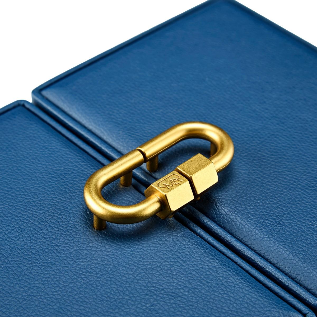 Close-up of the gold carabiner-shaped clasp on the WOLF 1834 Marla Aaron Baby Everything Jewellery Box, attached to textured blue vegan leather with visible fine stitching.