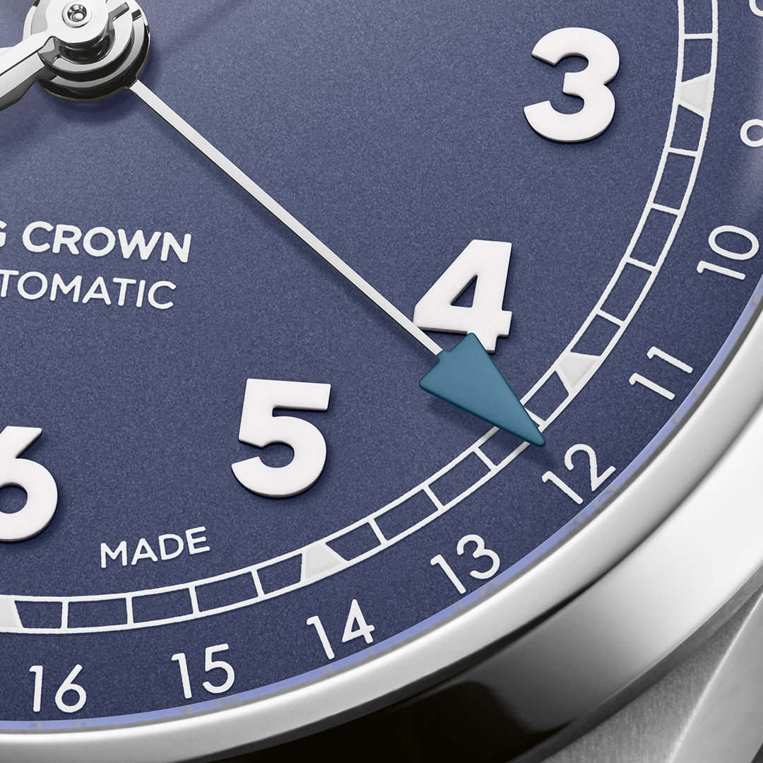 Close-up of the Oris Big Crown Pointer Date Calibre 754 Automatic Winding 40mm watch, featuring "SWISS MADE" and elegant silver hands sweeping over numerals. A blue arrow indicates the date against a refined blue background, showcasing its automatic mechanical movement by ORIS.