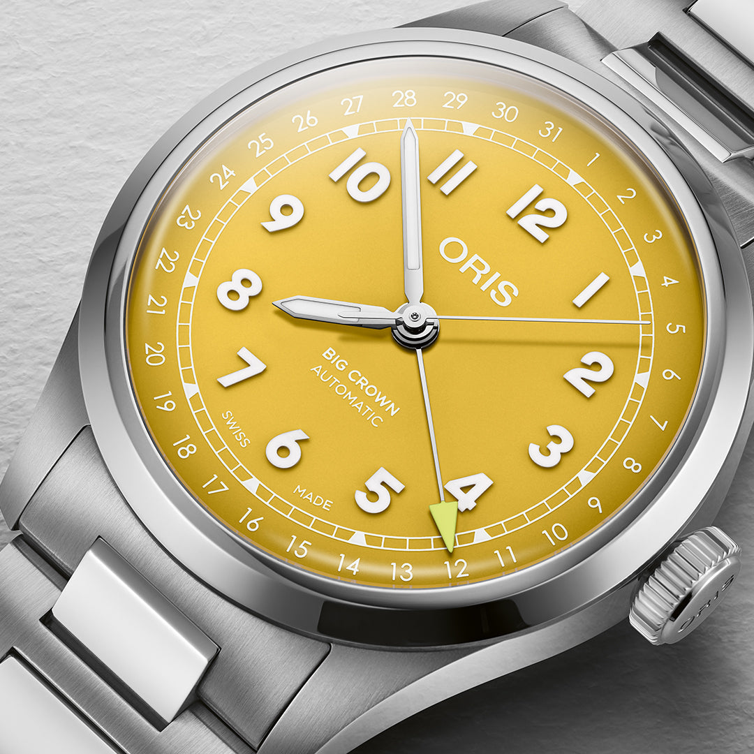 A close-up of the Oris Big Crown Pointer Date Calibre 754 Automatic Winding 40mm Watch showcases a sunshine yellow dial with bold white numerals. The Swiss Made movement is encased in silver stainless steel and features the ORIS brand below 12 o'clock alongside the date indicator.