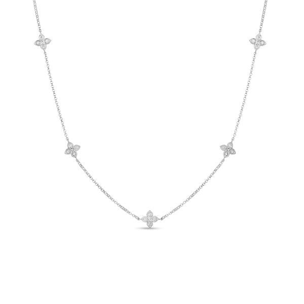 The Roberto Coin Love by the Inch necklace features five diamond flower stations on an adjustable 18K white gold chain, shown against a plain white background.