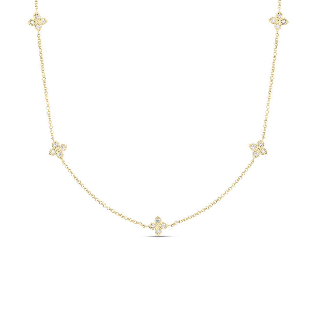 The Roberto Coin Love by the Inch 18K Yellow Gold Diamond 5 Station Flower Necklace showcases five floral diamond clusters (0.22 TCW) along an adjustable fine chain, displayed on a white background.