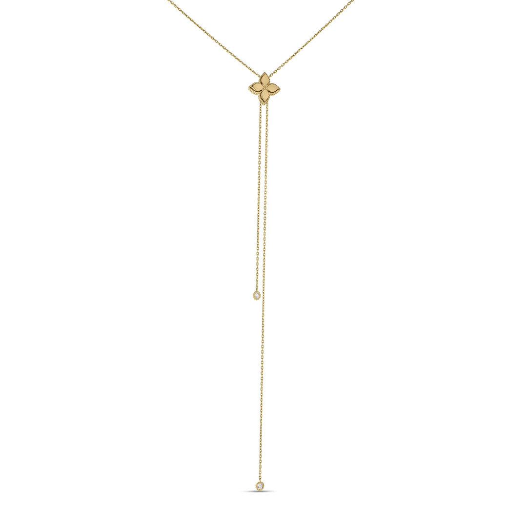 The Roberto Coin Princess Flower 18K Yellow Gold Diamond Accent Lariat Necklace features a delicate clover pendant and two fine chains of varying lengths, each ending in a small round detail, for a minimal and elegant look.