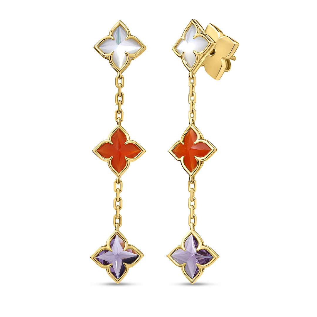 The Roberto Coin Venetian Princess Carnival Mixed Stones 18K Yellow Gold Flower Dangle Earrings feature three four-petal floral motifs in white, red agate, and purple enamel, linked by gold chains with a polished, symmetrical design.
