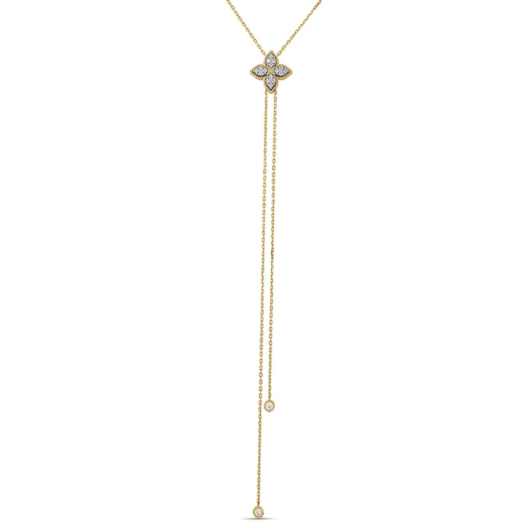 Experience the refined elegance of the Roberto Coin Princess Flower 18K Yellow Gold Pave Diamond Lariat Necklace. This minimalistic piece by Roberto Coin features a stunning four-petal floral motif pendant adorned with sparkling pavé diamonds at its center. Two long, delicate chains extend gracefully from the necklace, each finished with a subtle diamond accent for an exquisitely sophisticated touch.